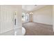 Inviting foyer with tile flooring that opens up to a carpeted living room filled with natural light at 1426 Natrona Dr, North Port, FL 34286