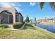 Lovely home exterior featuring a screened-in porch, well-manicured lawn, and a serene pond with a charming gazebo at 1890 Deborah Dr # 14, Punta Gorda, FL 33950