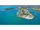Stunning aerial view of waterfront homes with pools, docks, and boats on the serene waters in a tropical paradise at 18938 Ayrshire Cir, Port Charlotte, FL 33948