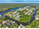 Aerial view of the community nestled along scenic canals with boats docked at many homes at 18938 Ayrshire Cir, Port Charlotte, FL 33948