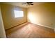 Cozy bedroom with neutral walls, ceiling fan, and a window letting in natural light at 18938 Ayrshire Cir, Port Charlotte, FL 33948