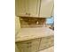 Kitchen with white cabinets, granite counters, tile backsplash, window, and stainless steel dishwasher at 18938 Ayrshire Cir, Port Charlotte, FL 33948