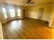 Bright living room with light hardwood floors, ceiling fan, and sunny bay window at 18938 Ayrshire Cir, Port Charlotte, FL 33948