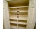 Pantry with storage shelving and double doors, perfect for organized food or supply storage at 18938 Ayrshire Cir, Port Charlotte, FL 33948