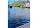 A waterfront view reveals a serene canal with boat dock, set against a backdrop of lush greenery at 18938 Ayrshire Cir, Port Charlotte, FL 33948