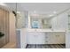 Modern bathroom featuring dual sinks and a glass-enclosed shower at 1960 Oregon Trl # 2B, Englewood, FL 34224