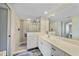 A modern bathroom with a large mirror and textured tile shower at 1960 Oregon Trl # 2B, Englewood, FL 34224