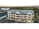 Three-story condominium building with a metal roof, multiple balconies, and a convenient parking area at 1960 Oregon Trl # 2B, Englewood, FL 34224