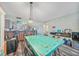Open-concept dining area with stylish lighting and view to the kitchen at 1960 Oregon Trl # 2B, Englewood, FL 34224
