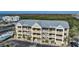 Multi-story condo building boasting private balconies, lush greenery, and ample parking space at 1960 Oregon Trl # 2B, Englewood, FL 34224