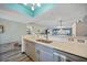 Kitchen with marble countertops and stainless appliances flows into the living space at 1960 Oregon Trl # 2B, Englewood, FL 34224