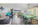 Open-concept living and dining area with wood floors and access to balcony at 1960 Oregon Trl # 2B, Englewood, FL 34224