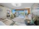 Bright living room with sliding doors to balcony offering scenic views at 1960 Oregon Trl # 2B, Englewood, FL 34224