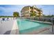 Community pool with a light blue hue and building in the background at 1960 Oregon Trl # 2B, Englewood, FL 34224