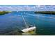 Seascape featuring a partially submerged sailboat in clear water, surrounded by calm waters, and distant coastline at 1960 Oregon Trl # 2B, Englewood, FL 34224