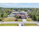 Expansive aerial view of a landscaped property with a two-car garage and surrounded by lush greenery at 23239 Stelling Ave, Punta Gorda, FL 33980