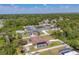 Aerial view of a quiet neighborhood with mature trees and a community pool at 23239 Stelling Ave, Punta Gorda, FL 33980