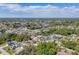 High angle view of a lush green neighborhood with mature trees and a community pool at 23239 Stelling Ave, Punta Gorda, FL 33980