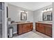Bathroom featuring dual vanities with granite countertops and wood cabinets at 23239 Stelling Ave, Punta Gorda, FL 33980