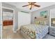 Comfortable bedroom features a bed with a colorful cover, a ceiling fan, and closet at 23239 Stelling Ave, Punta Gorda, FL 33980