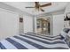 Bedroom with tile flooring, ceiling fan, and sliding door access to the screened pool area at 23239 Stelling Ave, Punta Gorda, FL 33980