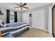 Bedroom featuring a ceiling fan, tile floors, window and double door closet at 23239 Stelling Ave, Punta Gorda, FL 33980