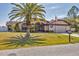 Charming one-story home featuring a palm tree in the front yard, a two-car garage and an American flag at 23239 Stelling Ave, Punta Gorda, FL 33980