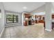 Open concept kitchen with stainless appliances, wood cabinets, tile floors, and desk space at 23239 Stelling Ave, Punta Gorda, FL 33980