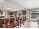 Open kitchen with a breakfast bar and a view of the outdoor pool area at 23239 Stelling Ave, Punta Gorda, FL 33980