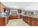 Well-lit kitchen with wooden cabinets, stainless steel appliances, and views to outdoor living space at 23239 Stelling Ave, Punta Gorda, FL 33980
