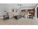 Open-concept living area with tiled floors seamlessly flows into the kitchen and backyard at 23239 Stelling Ave, Punta Gorda, FL 33980
