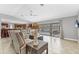Open-concept living area with tiled floors seamlessly flows into the kitchen and screened-in patio at 23239 Stelling Ave, Punta Gorda, FL 33980