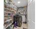 Walk-in pantry equipped with shelves filled with food, as well as a washing machine at 23239 Stelling Ave, Punta Gorda, FL 33980