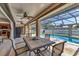 Outdoor patio with dining set overlooking a swimming pool and screened enclosure at 23239 Stelling Ave, Punta Gorda, FL 33980