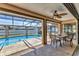 Outdoor patio with dining set overlooking a swimming pool and screened enclosure at 23239 Stelling Ave, Punta Gorda, FL 33980