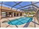 View of a screened-in pool area, patio dining set and access to the interior at 23239 Stelling Ave, Punta Gorda, FL 33980