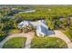 Aerial view of lush landscaping, grey roof and brick paver driveway at 27320 Egret Pl, Punta Gorda, FL 33983