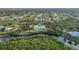 Waterfront estate aerial highlighting private dock, pool and lush greenery in a neighborhood setting at 27320 Egret Pl, Punta Gorda, FL 33983