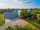 Aerial view of home with three-car garage, large driveway, and fenced-in yard with playset at 27320 Egret Pl, Punta Gorda, FL 33983