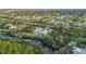 Aerial view featuring the home's private dock, in-ground pool, and surrounding community at 27320 Egret Pl, Punta Gorda, FL 33983