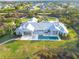 Expansive home features backyard pool, patio, lush lawn and manicured landscaping at 27320 Egret Pl, Punta Gorda, FL 33983