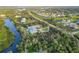 Secluded estate aerial showcases lush surroundings, private dock, and serene waterfront living at 27320 Egret Pl, Punta Gorda, FL 33983