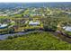 Stunning aerial view of waterfront home with private dock and lush green surroundings at 27320 Egret Pl, Punta Gorda, FL 33983