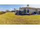 Expansive backyard with lush green lawn, swimming pool, and mature landscaping, perfect for outdoor living at 27320 Egret Pl, Punta Gorda, FL 33983