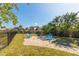 Private backyard patio with comfortable seating around a fire pit, perfect for outdoor entertaining and relaxation at 27320 Egret Pl, Punta Gorda, FL 33983