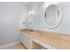 Elegant bathroom vanity featuring dual sinks, makeup area, and classic finishes at 27320 Egret Pl, Punta Gorda, FL 33983