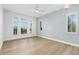 Bright bedroom with hardwood floors, multiple windows, stylish light fixture and neutral decor at 27320 Egret Pl, Punta Gorda, FL 33983
