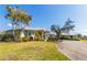 Spacious home with a well-manicured lawn and landscaping, including palm trees at 27320 Egret Pl, Punta Gorda, FL 33983