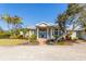 Inviting home featuring lush landscaping, a paved walkway, and a welcoming facade at 27320 Egret Pl, Punta Gorda, FL 33983