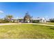Beautiful home with lush landscaping, green grass, and a charming facade at 27320 Egret Pl, Punta Gorda, FL 33983